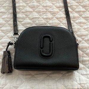 Marc Jacobs black cross body purse with leopard print strap and tassel.